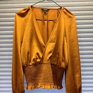 Gold/yellow ruched satin blouse with puff sleeves.